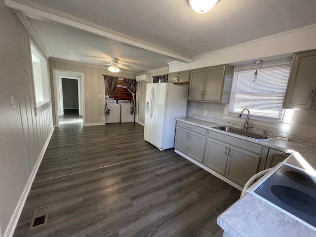 kitchen featuring independent washer and dryer, gray cabinetry, white fridge with ice dispenser, and sink