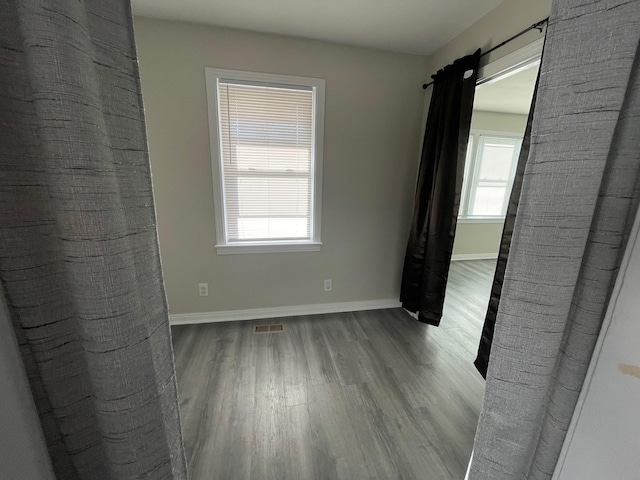 spare room with hardwood / wood-style flooring and a wealth of natural light