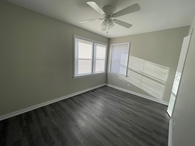 spare room featuring dark hardwood / wood-style floors and ceiling fan