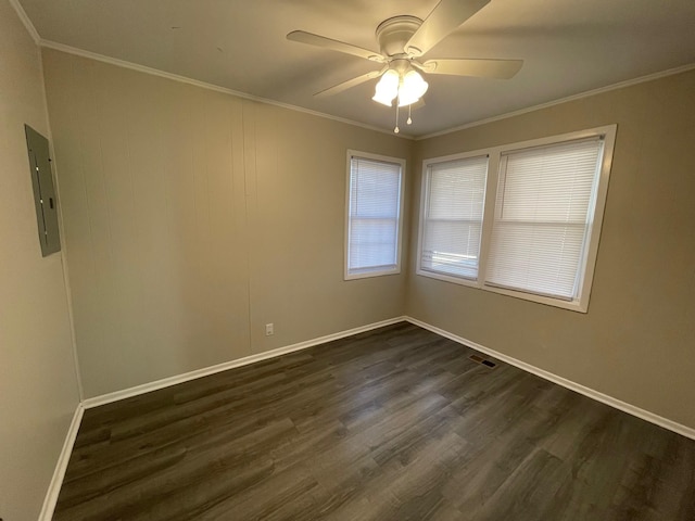 spare room featuring electric panel, ceiling fan, crown molding, and dark hardwood / wood-style floors