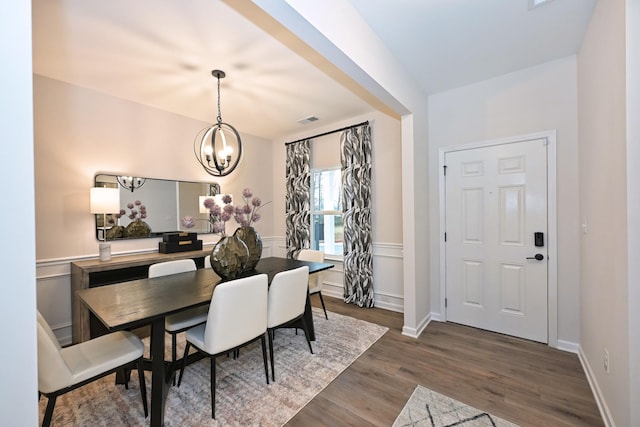 dining room featuring a notable chandelier and dark hardwood / wood-style flooring