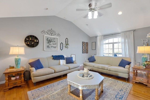 living room featuring light hardwood / wood-style floors, ceiling fan, and vaulted ceiling