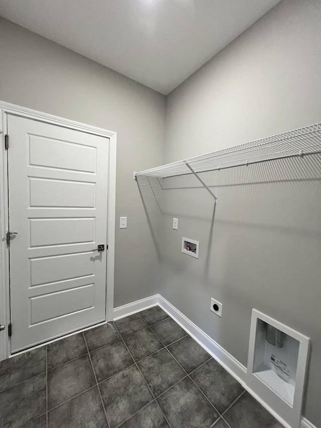 clothes washing area featuring hookup for a washing machine, dark tile patterned flooring, and electric dryer hookup