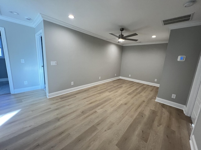 spare room featuring light wood-type flooring, ceiling fan, and ornamental molding