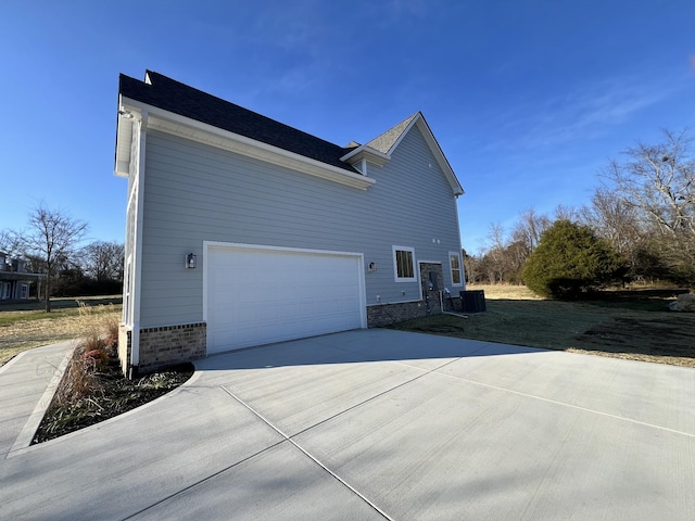 view of side of property with central AC unit and a garage