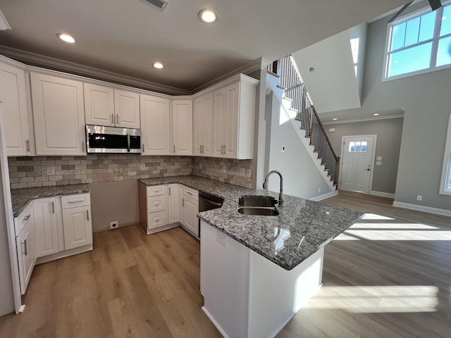 kitchen featuring kitchen peninsula and white cabinetry