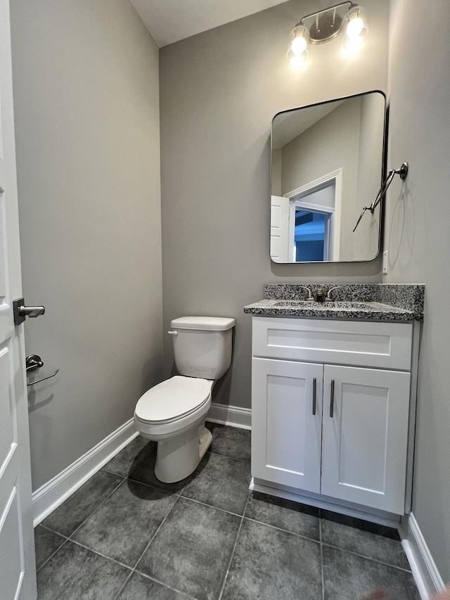 bathroom featuring tile patterned flooring, vanity, and toilet