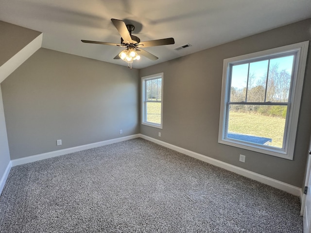 carpeted spare room with ceiling fan