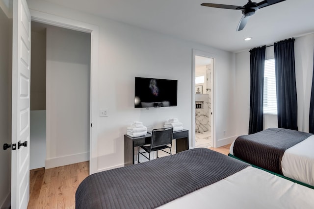 bedroom featuring ceiling fan, light hardwood / wood-style floors, and connected bathroom