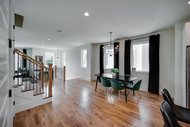 dining area featuring a chandelier, light wood-type flooring, and a wealth of natural light