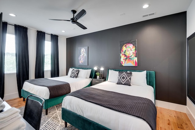 bedroom with multiple windows, ceiling fan, and light hardwood / wood-style flooring