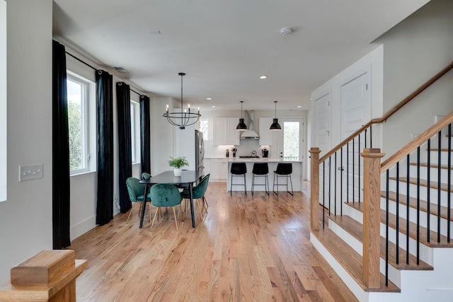 dining room with a chandelier and light hardwood / wood-style flooring