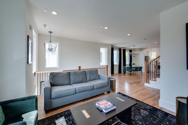 living room featuring a chandelier and hardwood / wood-style flooring