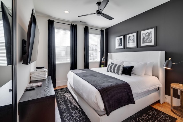 bedroom featuring hardwood / wood-style flooring and ceiling fan