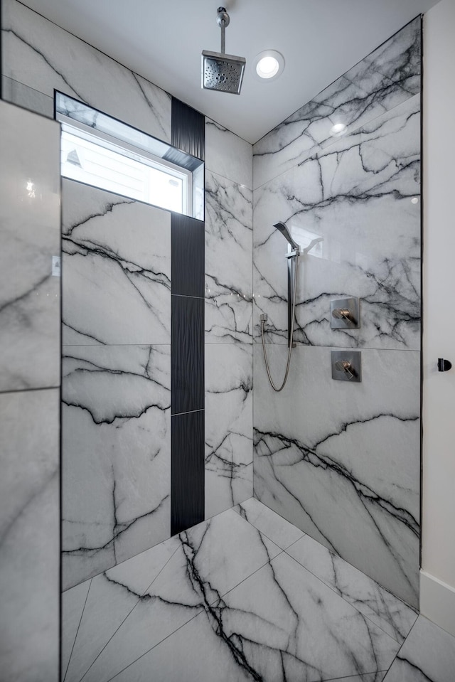 bathroom featuring a tile shower