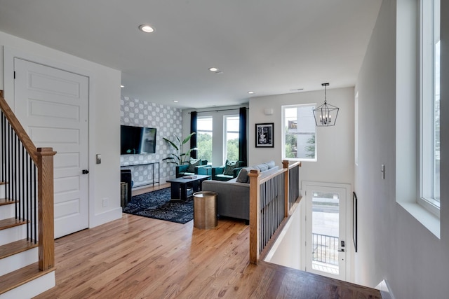 living room featuring light hardwood / wood-style floors and a notable chandelier