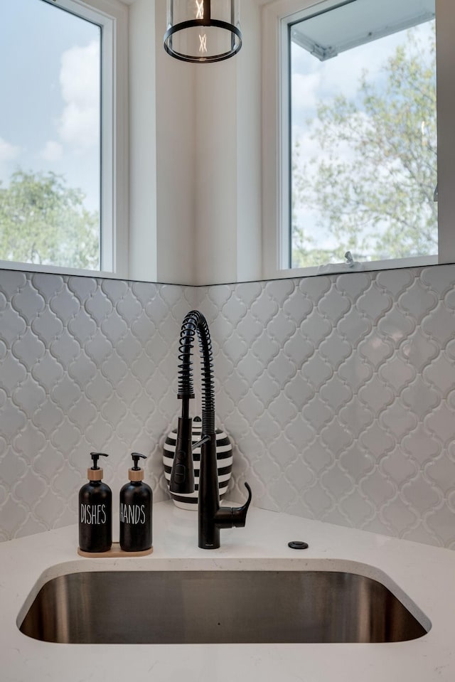 interior details featuring sink and backsplash