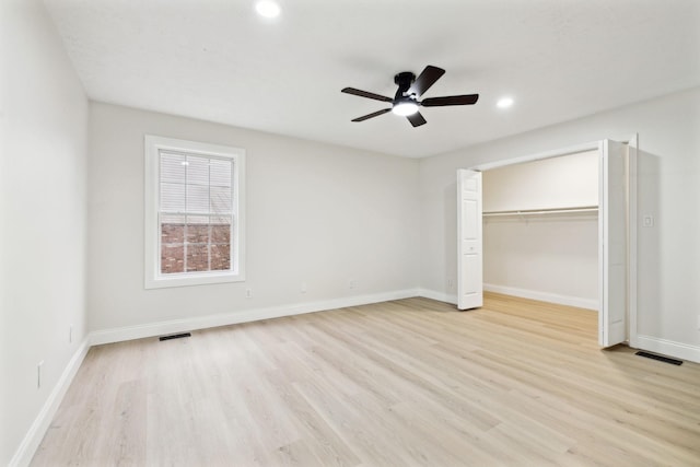 unfurnished bedroom featuring light wood-type flooring, a closet, and ceiling fan