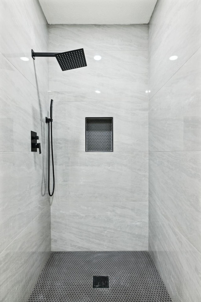 bathroom with tiled shower