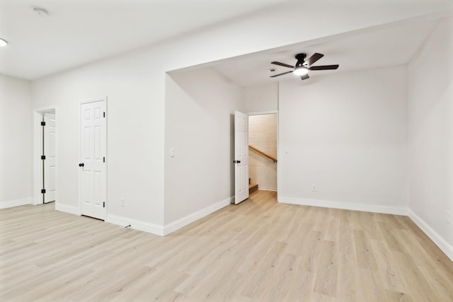 empty room with light hardwood / wood-style floors and ceiling fan