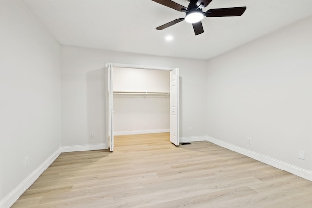 unfurnished bedroom with ceiling fan, light hardwood / wood-style floors, and a closet