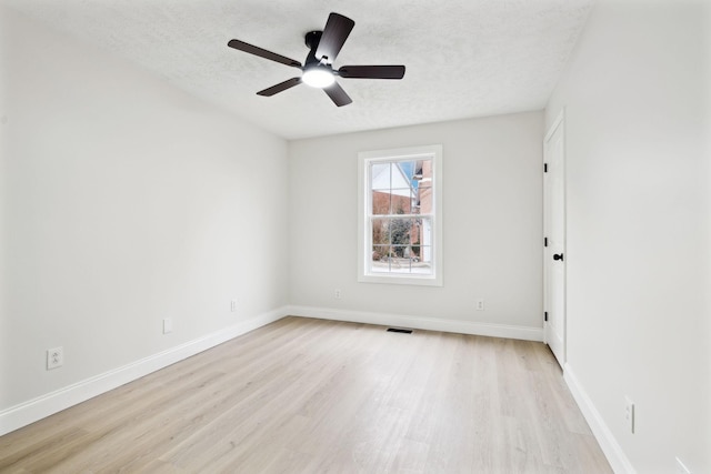 spare room with ceiling fan, light hardwood / wood-style floors, and a textured ceiling