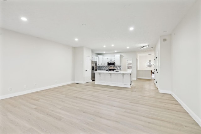 unfurnished living room with light hardwood / wood-style floors