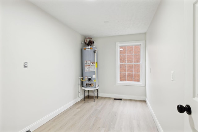 utility room with gas water heater