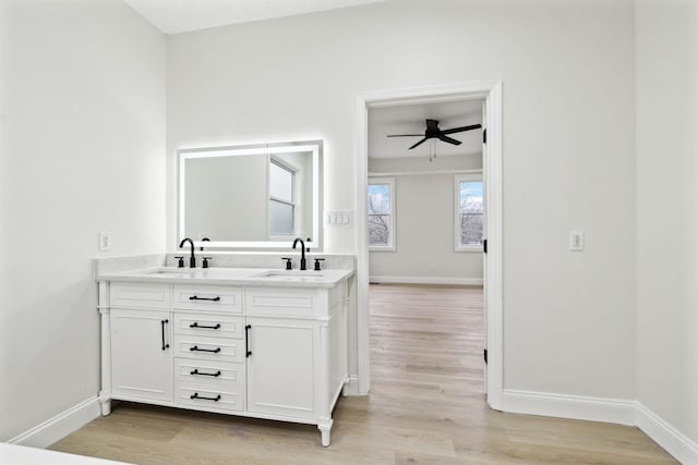 bathroom with vanity, ceiling fan, and wood-type flooring