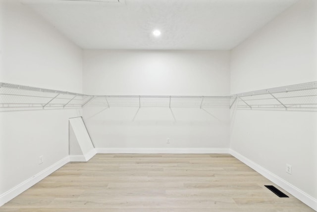 spacious closet featuring light hardwood / wood-style flooring