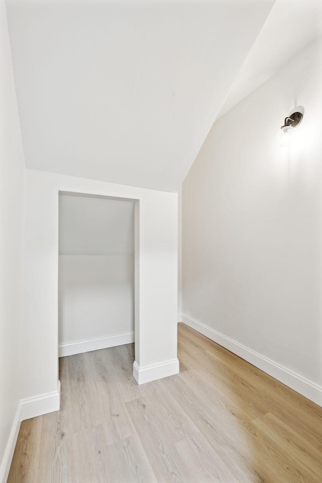 bonus room with light hardwood / wood-style flooring and lofted ceiling