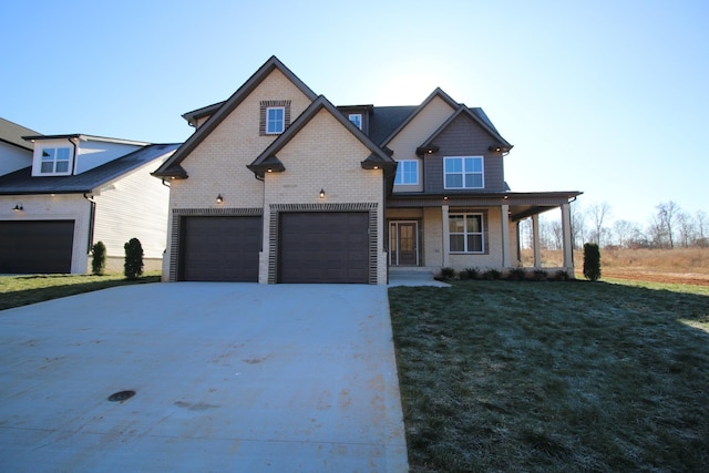 view of front of house featuring a porch, a garage, and a front lawn