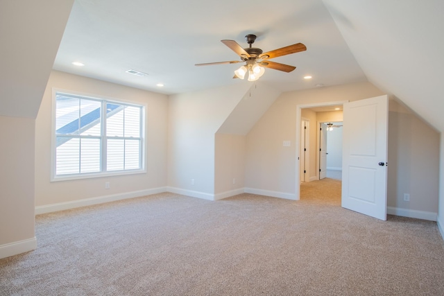 bonus room featuring ceiling fan, light colored carpet, and vaulted ceiling