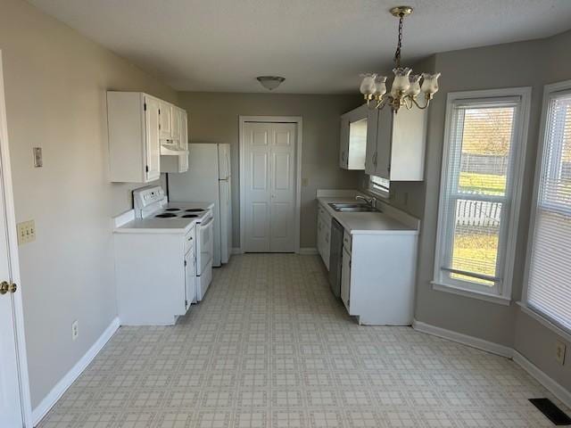 kitchen featuring white cabinetry, sink, stainless steel dishwasher, white range with electric cooktop, and a chandelier