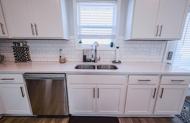 kitchen featuring sink, dark hardwood / wood-style floors, white cabinets, decorative backsplash, and stainless steel dishwasher