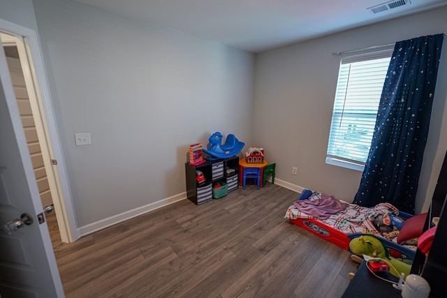 game room featuring dark wood-type flooring