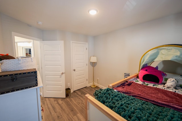 bedroom with wood-type flooring