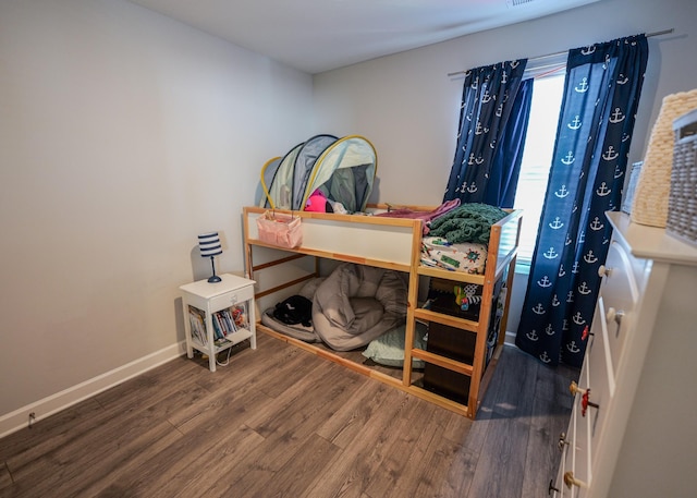 bedroom featuring wood-type flooring and multiple windows