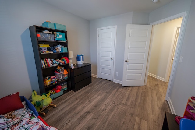 bedroom with dark hardwood / wood-style flooring