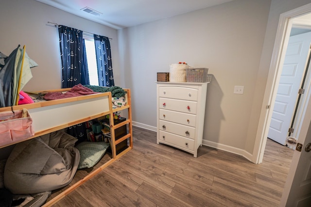 bedroom with hardwood / wood-style floors