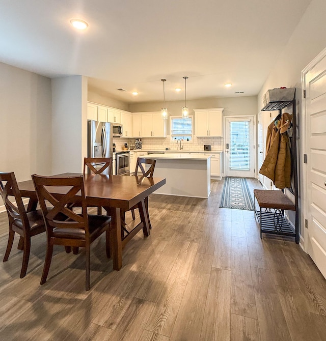 dining space with hardwood / wood-style flooring