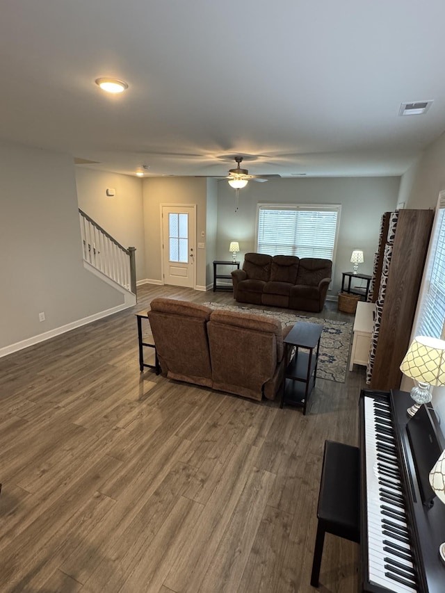 living room with dark hardwood / wood-style floors and ceiling fan