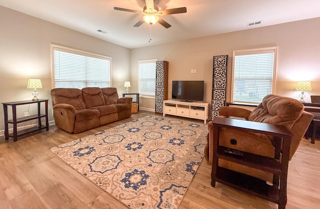 living room with light hardwood / wood-style floors and ceiling fan