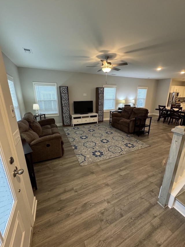 living room with ceiling fan and hardwood / wood-style floors