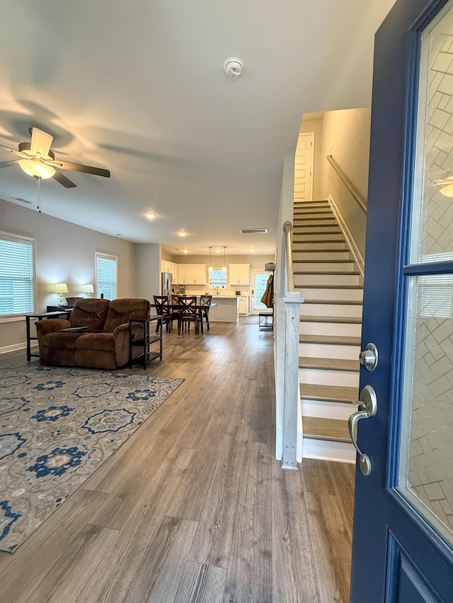 living room featuring hardwood / wood-style flooring and ceiling fan