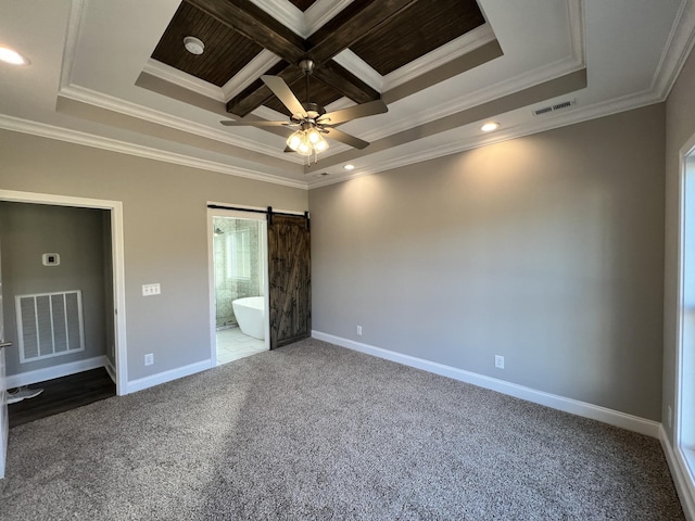 unfurnished bedroom featuring connected bathroom, a barn door, crown molding, and coffered ceiling