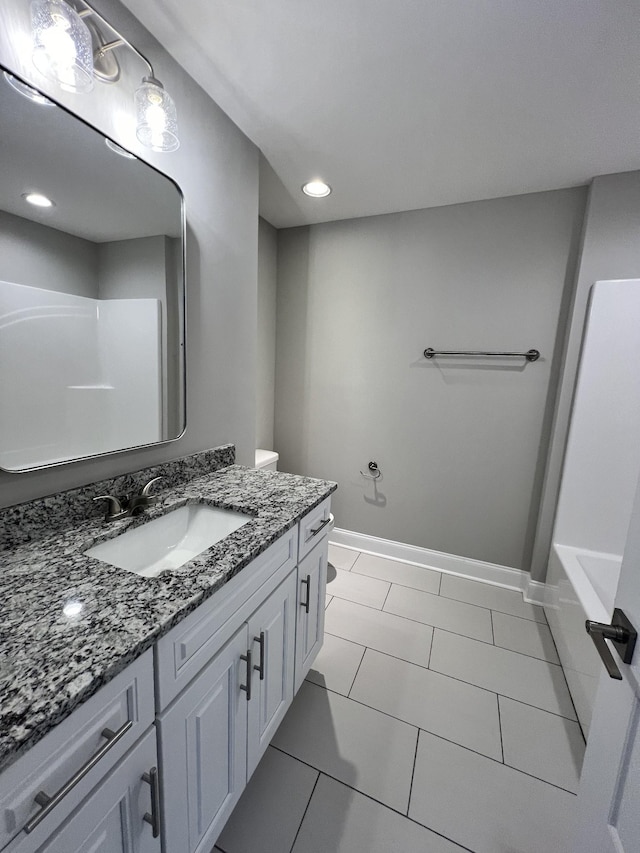 bathroom featuring tile patterned floors, vanity, and toilet