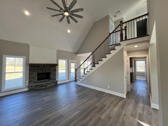 unfurnished living room with a stone fireplace, ceiling fan, high vaulted ceiling, and dark hardwood / wood-style floors