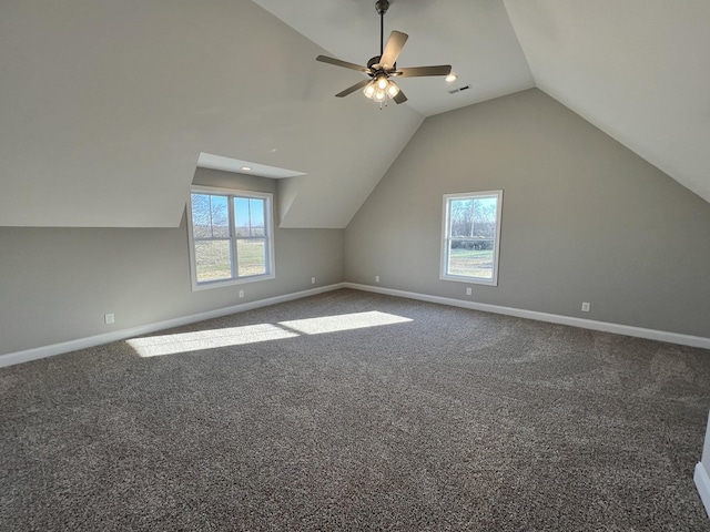 additional living space featuring ceiling fan, plenty of natural light, carpet floors, and lofted ceiling