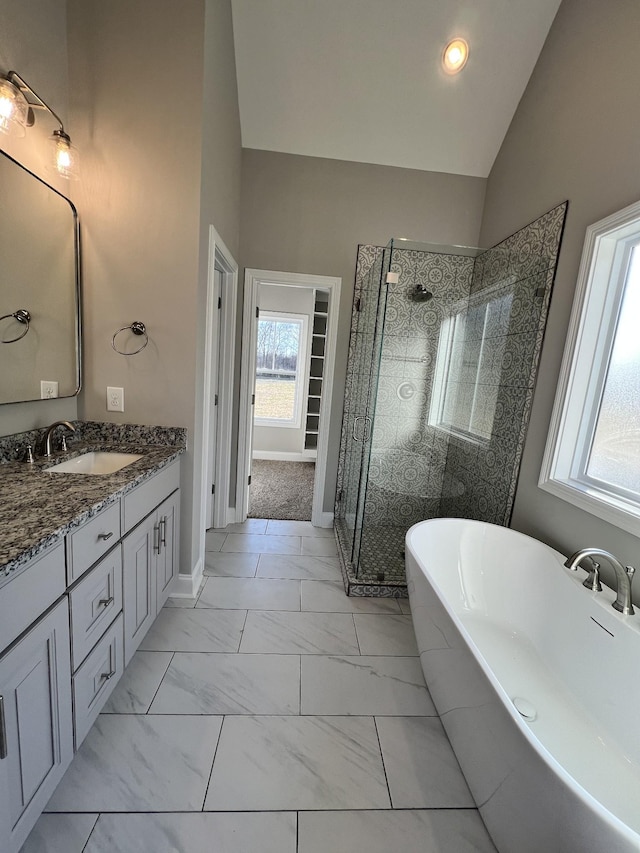 bathroom featuring a wealth of natural light, vanity, independent shower and bath, and lofted ceiling